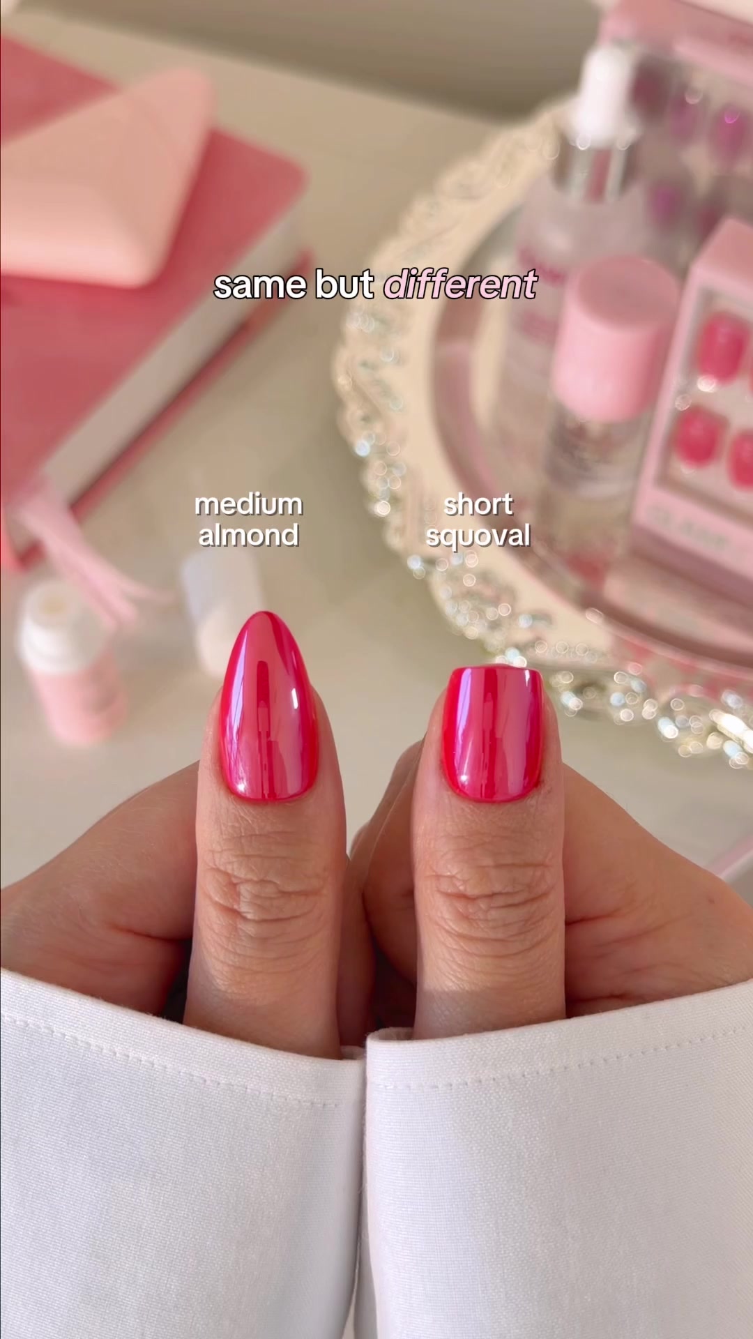 Two hands are shown, each displaying a different nail shape and length. The left hand has a medium almond-shaped nail, labeled "medium almond." The right hand has a shorter, squoval-shaped nail, labeled "short squoval." Text overlaying the image reads "same but different." The background features blurred pink items and beauty products.