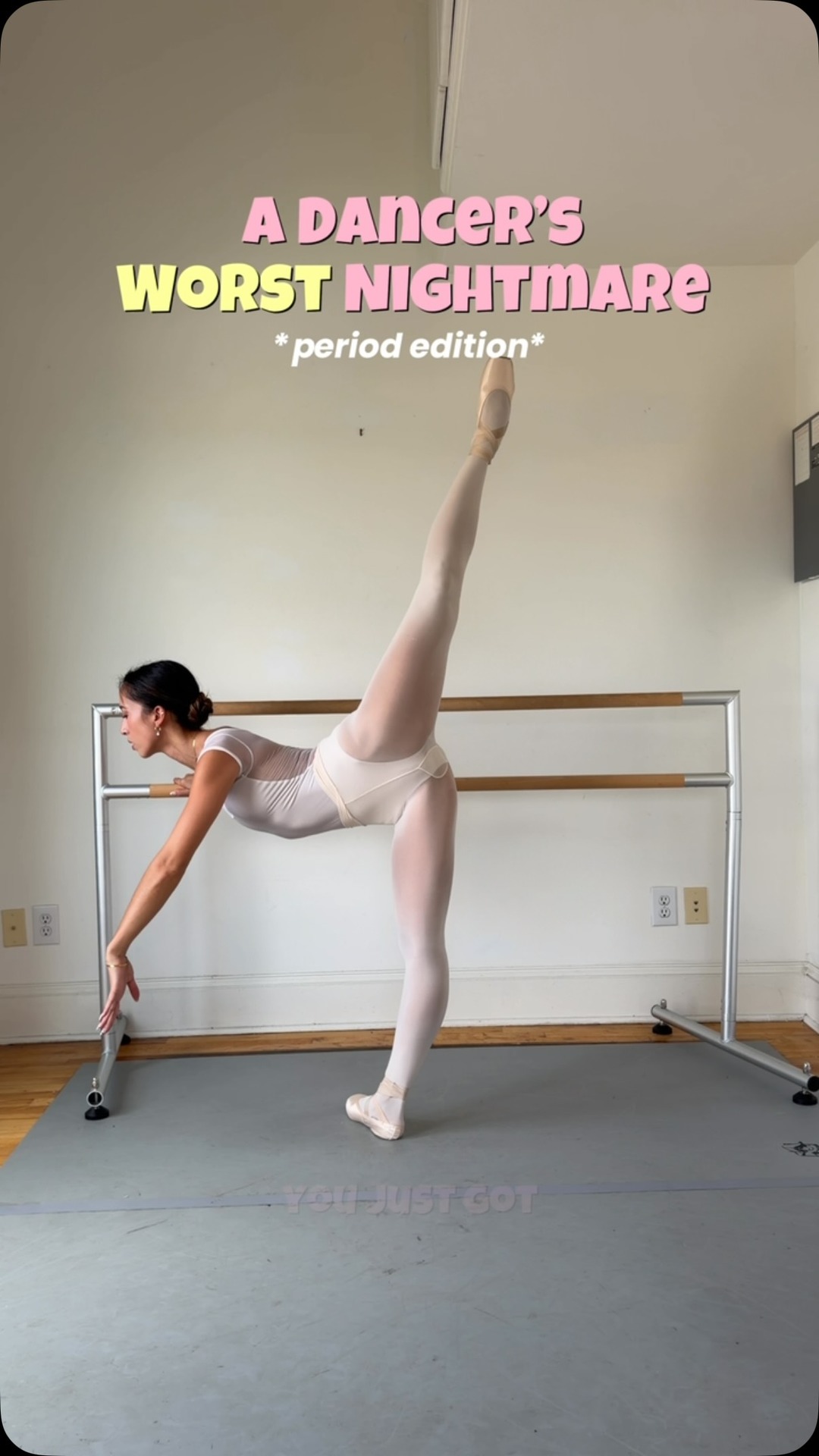 A ballerina in a dance studio is captured mid-pose, with her leg extended high in the air. The text overlay reads "A DANCER'S WORST NIGHTMARE *period edition*" in large, stylized fonts. The image highlights the challenges dancers might face, particularly related to their menstrual cycle, suggesting a relatable struggle within the demanding world of dance.