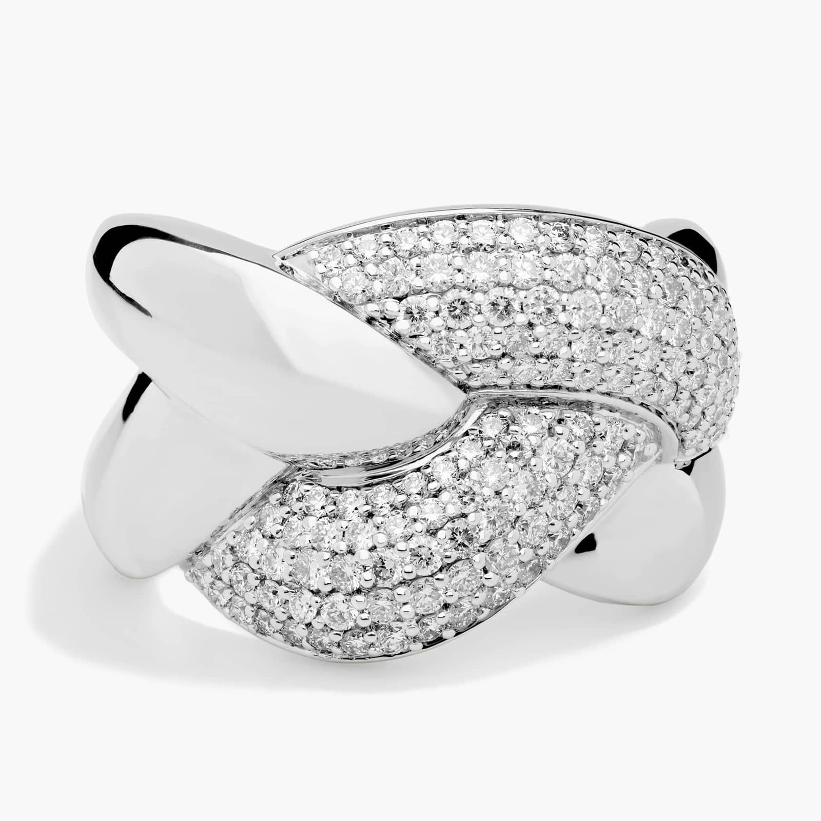 A close-up studio shot of a white gold ring encrusted with numerous small diamonds. The ring has a unique, intertwined design with polished metal sections contrasting with the paved diamond sections. The background is a plain, light grey. The text overlay reads: "Sometimes it’s good to get lost in the details. Especially when they’re this brilliant and luminous."