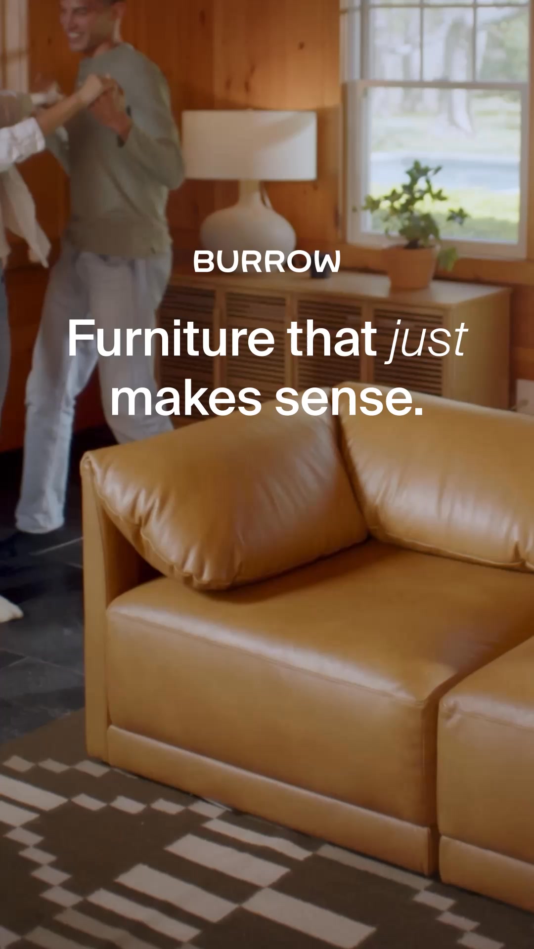 A couple is dancing in a cozy living room with a Burrow sofa in the foreground. The text overlay reads "BURROW" at the top and "Furniture that just makes sense." below it. The scene depicts a warm, inviting home environment, highlighting the furniture's aesthetic appeal and the lifestyle it supports. The overall impression is one of comfort, style, and ease of living.