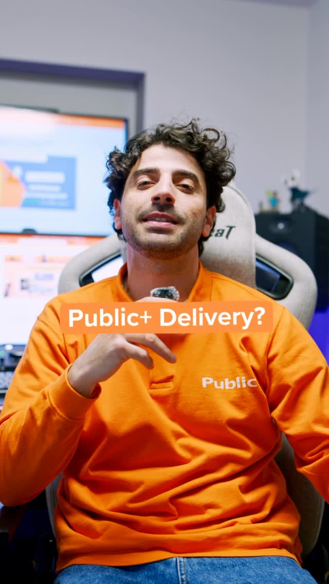 A man wearing an orange long-sleeved shirt with the word "Public" on it is sitting in a chair and looking at the camera. Text overlays on the image read "Public+ Delivery?" and "Public". The man is gesturing with his hand. The background appears to be an office or studio setting with computer monitors visible. The ad is promoting a new delivery service from Public.