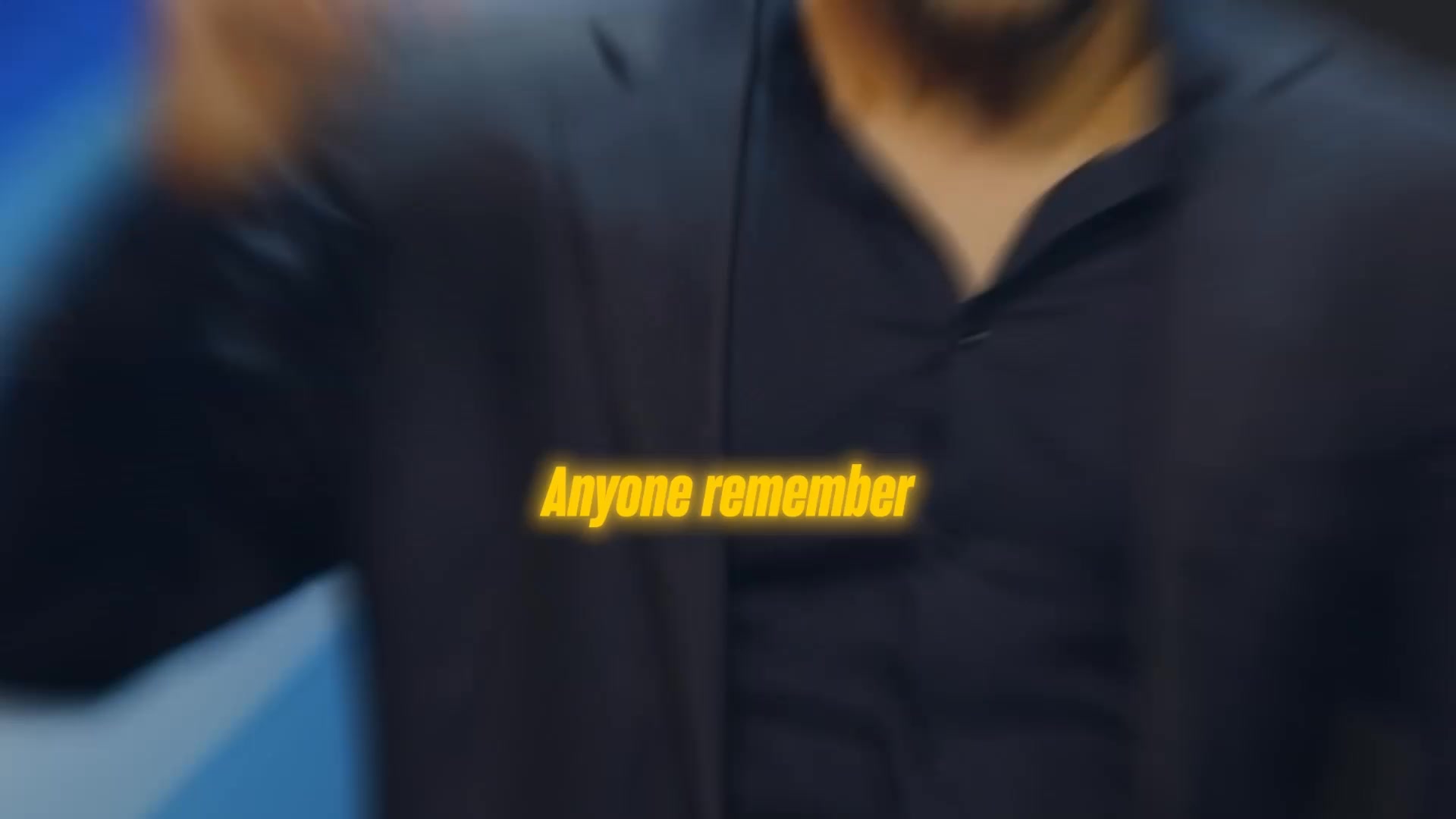 The creative is a text-only format with a yellow, glowing text overlay that reads "Anyone remember". The background is blurred and dark, showing a person in a dark suit. The text is positioned in the center of the frame, suggesting a question or a prompt for the viewer to recall something from the past.