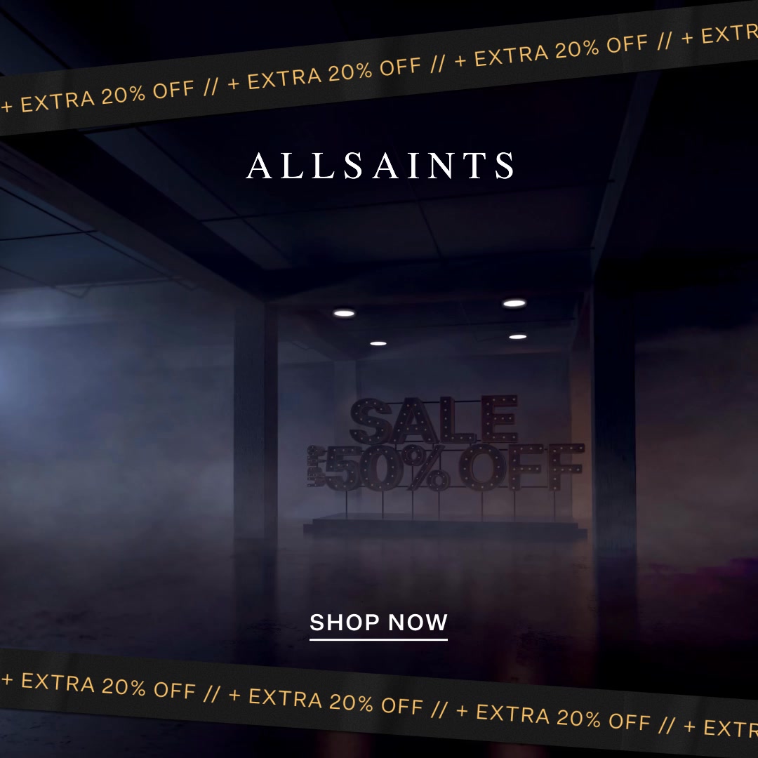 The image shows a dark, atmospheric retail space with the brand name ALLSAINTS displayed prominently at the top. In the center, illuminated marquee letters spell out "SALE 50% OFF". A "SHOP NOW" button is visible below the sale sign. A dark ribbon with repeating text "+ EXTRA 20% OFF" runs across the top and bottom of the image, framing the scene.