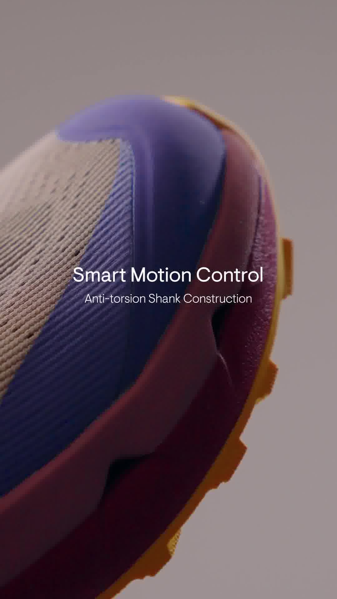 A close-up, angled shot of a sneaker focuses on its sole and upper. The text "Smart Motion Control" is displayed prominently in white, followed by the smaller text "Anti-torsion Shank Construction" below it. The lighting is soft, highlighting the textures and layered design of the shoe, with a blurred background that complements the shoe's colors.
