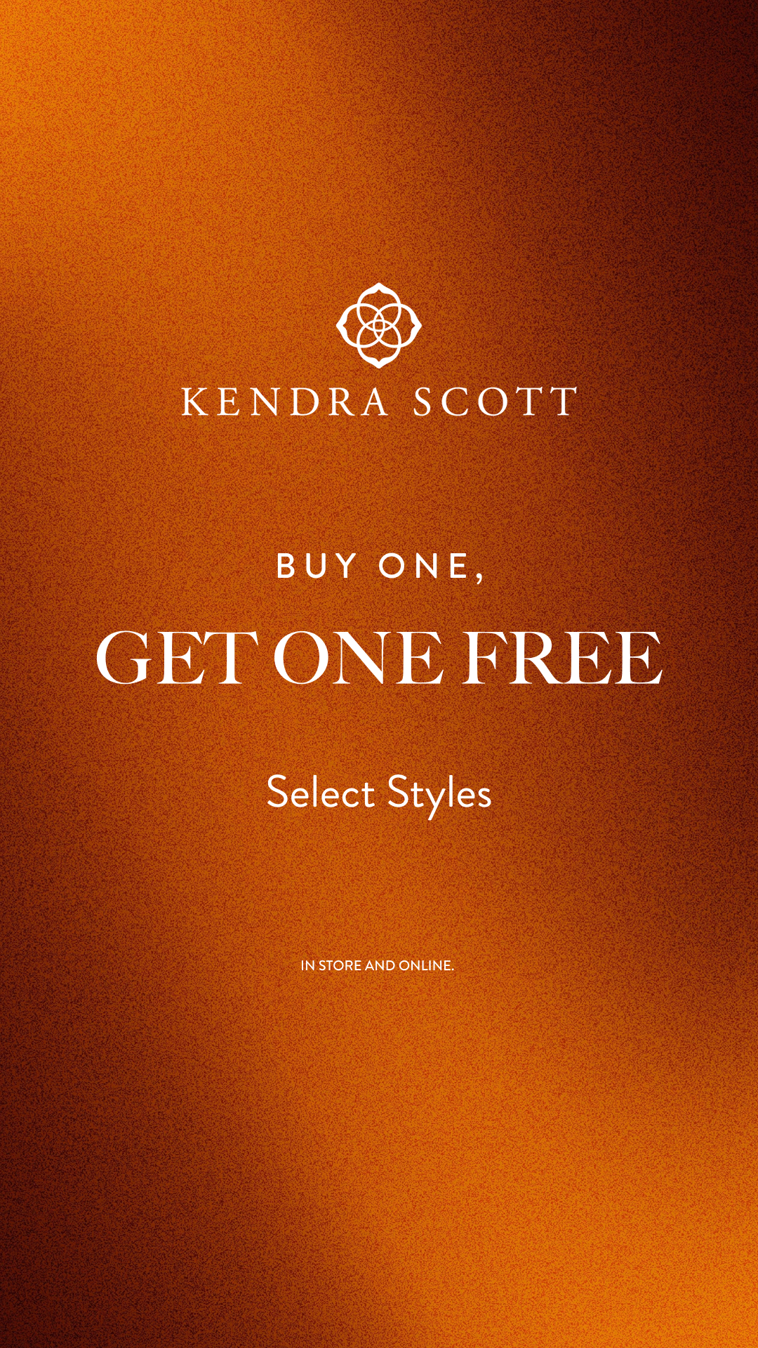 The creative features a textured, gradient background in shades of orange and brown. Prominently displayed in the center are the words "BUY ONE, GET ONE FREE" in large, white, serif font. Above this, "BUY ONE," is written in a smaller font, and below it, "Select Styles" appears in a similar smaller font. At the bottom, the text "IN STORE AND ONLINE." is visible. The Kendra Scott logo is subtly placed at the top center.