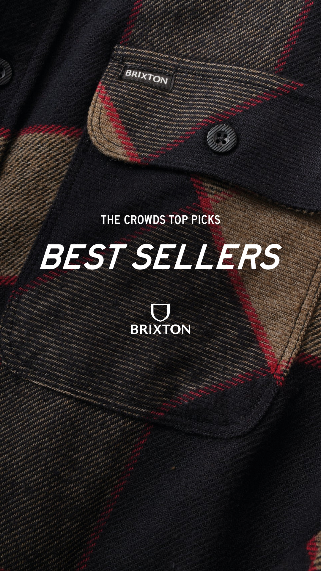 A close-up, detailed shot of a dark plaid flannel shirt. The fabric shows a pattern of black, brown, and thin red lines. Prominently displayed on the shirt are two chest pockets, one with a black "BRIXTON" label and a button. Overlayed text reads "THE CROWDS TOP PICKS" in a smaller font and "BEST SELLERS" in a large, bold white font. Below "BEST SELLERS" is a shield logo with "BRIXTON" written underneath it.