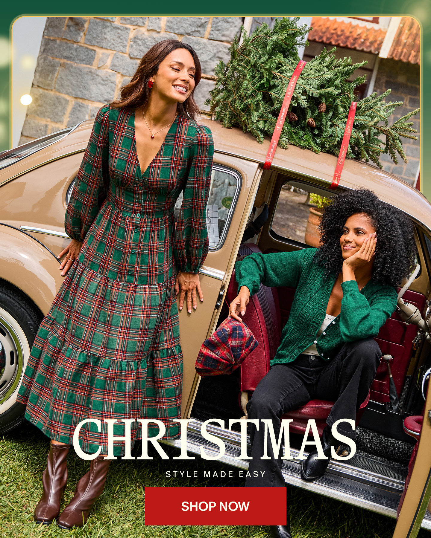Two women are posing next to a vintage car, with a Christmas tree strapped to the roof. The woman on the left wears a green and red plaid dress, while the woman on the right wears a green cardigan and black pants. The text "CHRISTMAS STYLE MADE EASY" is overlaid on the image, with a "SHOP NOW" button below it. The overall scene evokes a festive and stylish holiday mood.
