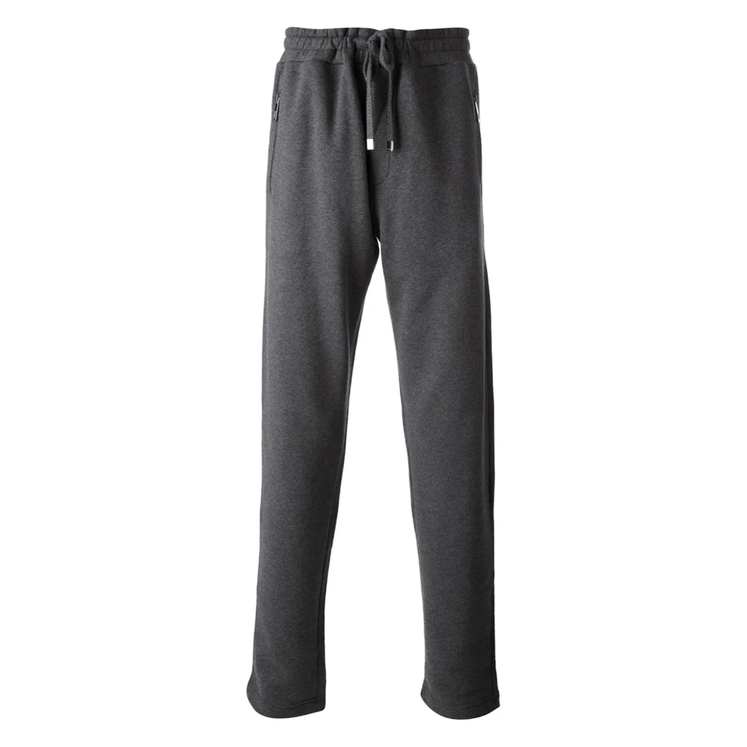 A pair of dark grey sweatpants is shown against a white background. The sweatpants have a drawstring waist, zippered pockets on the sides, and a relaxed fit. The image is a clean product shot, with no text overlay or additional elements.