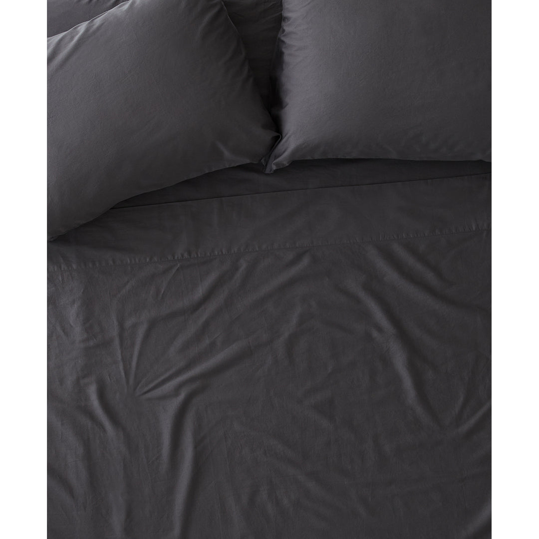 A top-down view of a dark grey bed with two pillows and a flat sheet. The text "Fresh start, better sleep." is overlaid on the image. The copy mentions a 20% off sale on organic bedding.